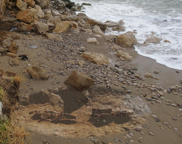 Archaeologists removed the remains before the next storm reclaimed the beach. This superimposition shows the location of the tomb