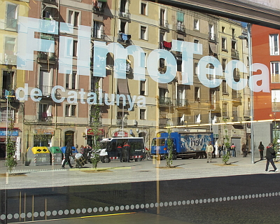 El Raval reflected in the window of the FilmoTeca flagship