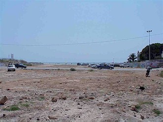The mouth of the Riera de la Bisbal: channel used for car parking and crossed by the main coast road